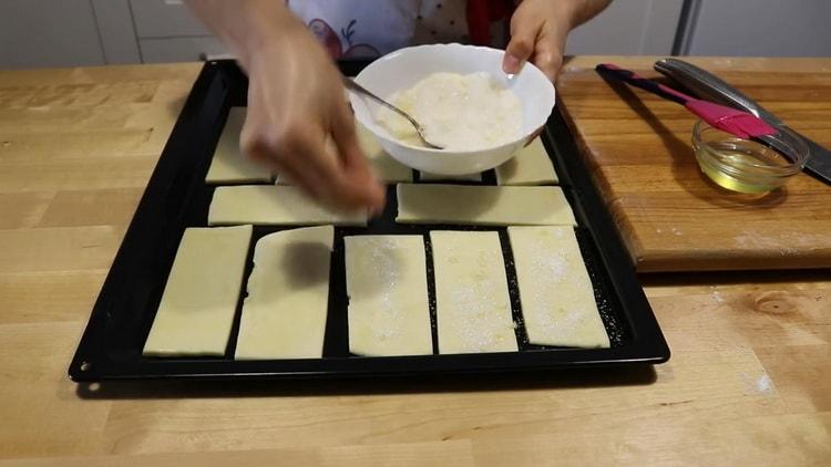To prepare cookies from puff yeast-free dough, sprinkle with dusting