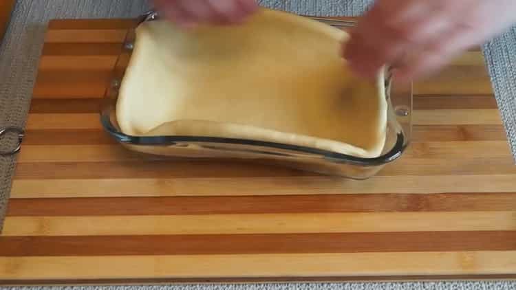 To prepare a pie with mushrooms in the oven, put the dough in the mold