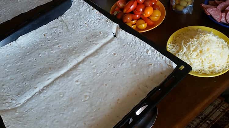 To make pizza from pita bread in the oven, prepare a form