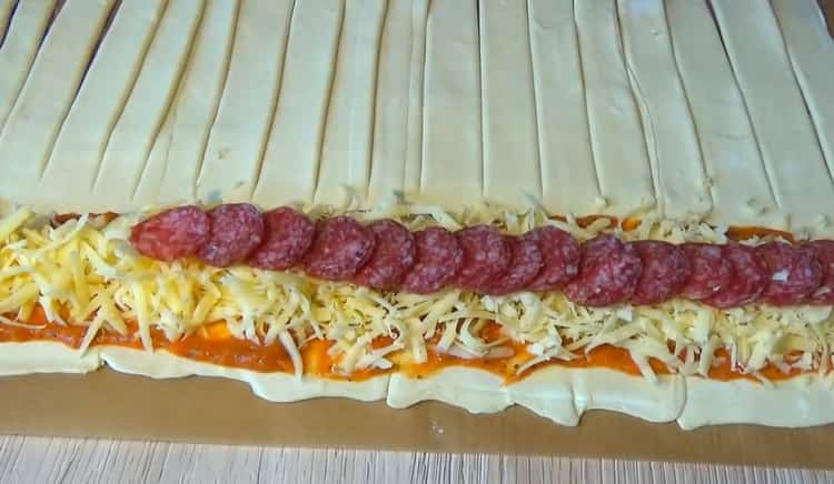 To make puff pastry pizza, put the sauce and filling on the dough
