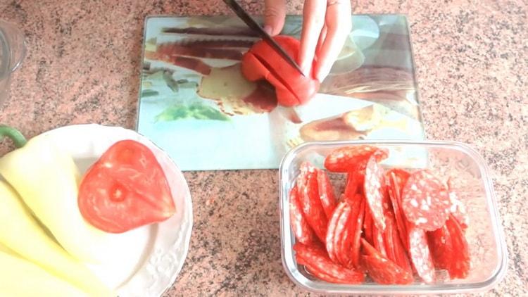 To make puff pastry pizza in the oven, chop the tomatoes