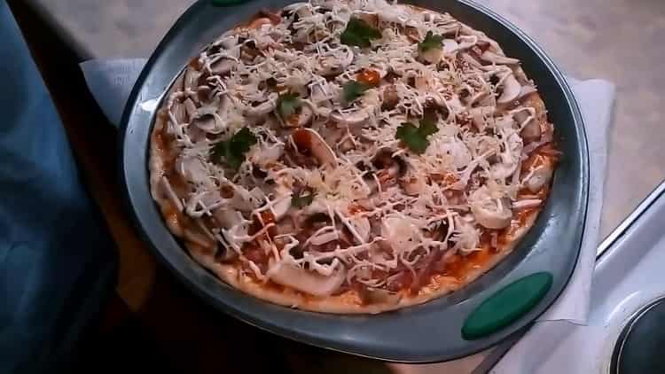 To make pizza with mushrooms and cheese, preheat the oven