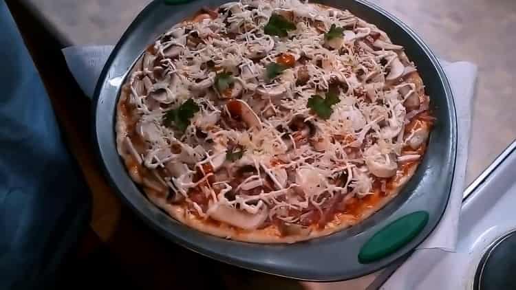 Pour faire une pizza aux champignons et au fromage, préchauffez le four