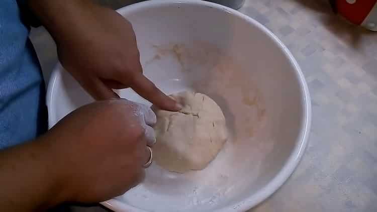 Kneed het deeg om pizza met champignons en kaas te maken.