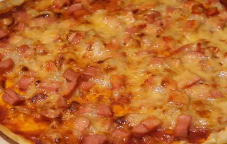 pizza with sausage and cheese is ready