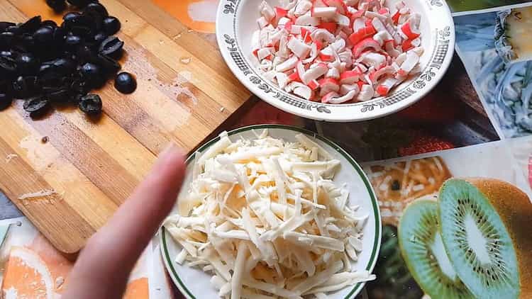 To make pizza with crab sticks, grate cheese