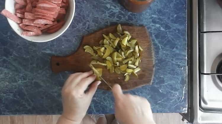 To make pizza with pickles, chop the cucumbers
