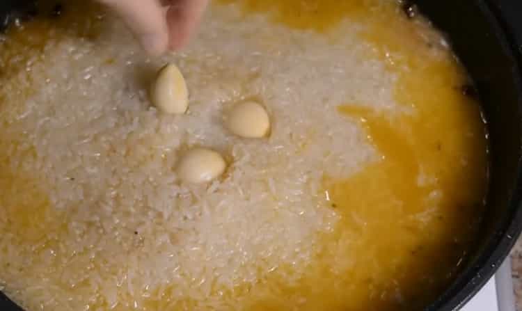 To make lamb pilaf in a cauldron, add garlic