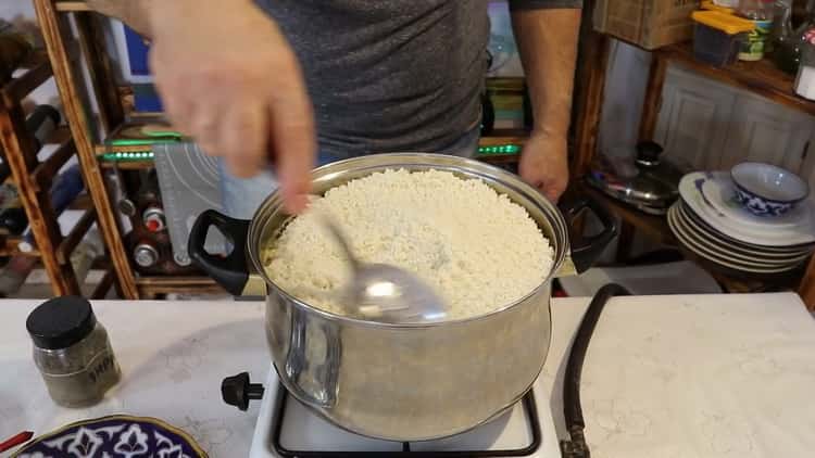 To cook pork pilaf in a pan add rice