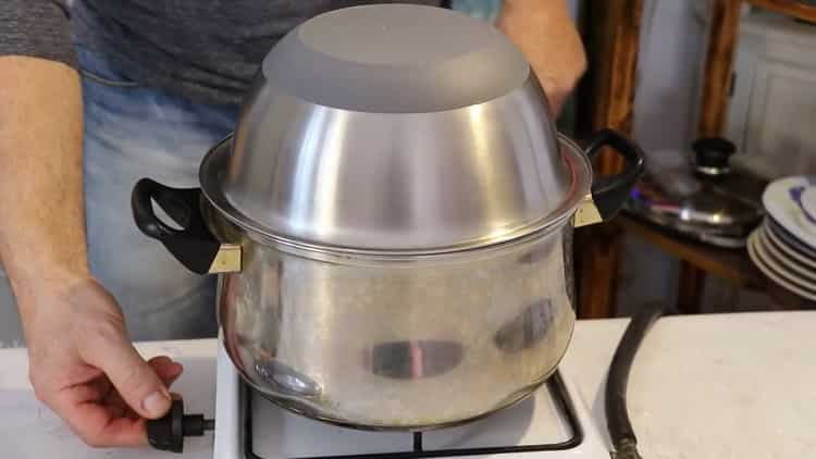 To cook pork pilaf in a pan, cover with a lid