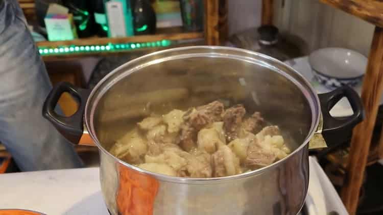 To cook pork pilaf in a pan, fry the meat