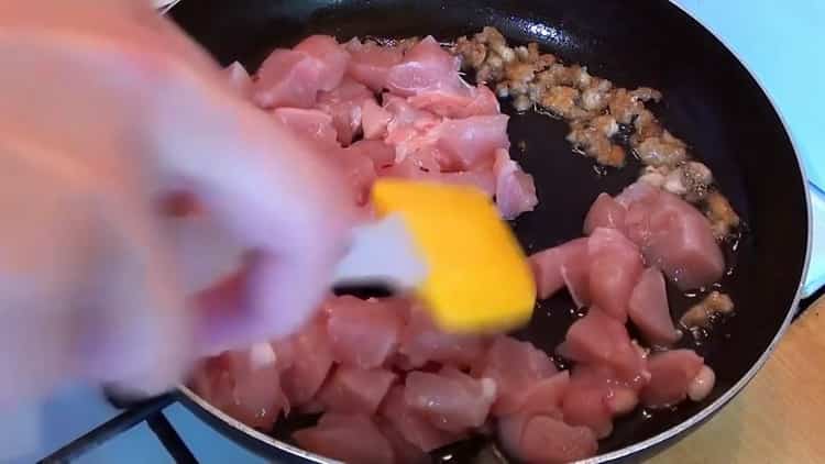 To cook pilaf with chicken in a pan, fry the meat