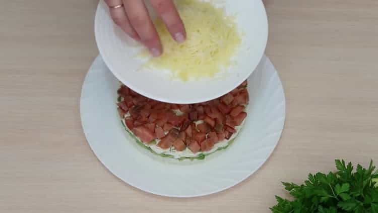 To make a salad with avocado and salmon, grate cheese