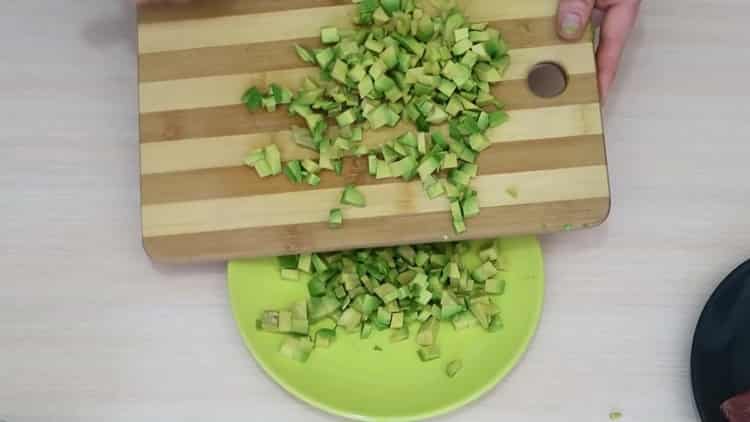 To make a salad with avocado and salmon, chop the avocado
