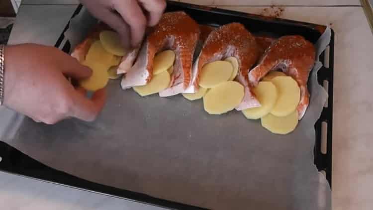 Pour faire cuire le saumon avec les pommes de terre au four, hachez-les