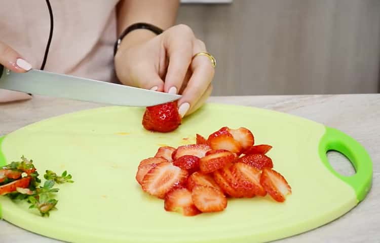 To make sweet pizza, chop strawberries