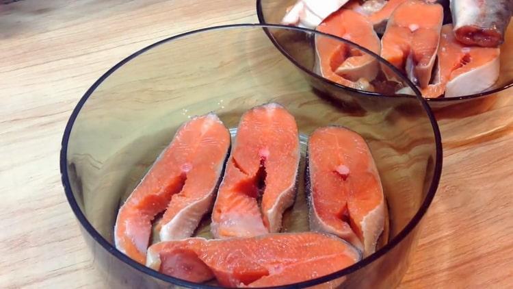 To cook pink salmon steaks, marinate the fish