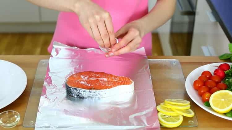 To cook a salmon skate in the oven, salt the steak