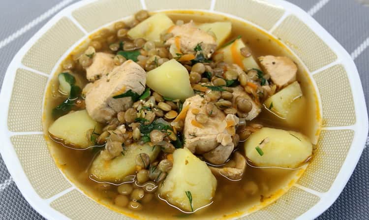 A delicious soup with lentils and chicken is ready.