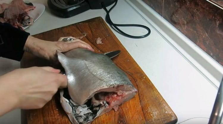 Gently cut the fish in half.