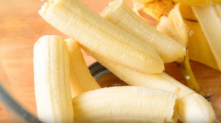 Ripe bananas are broken into pieces and put in a bowl.