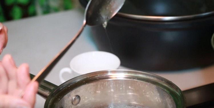 The syrup is ready when a caramel string stretches from a spoon lowered into it.