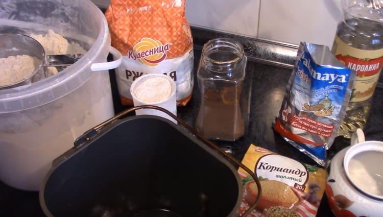 Pour water into a bucket of a bread machine.