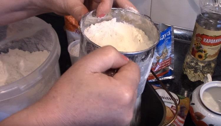 Sift flour directly into a bucket of a bread machine.