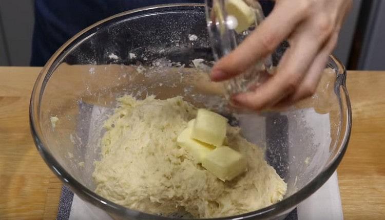 Add butter to the sticky dough.