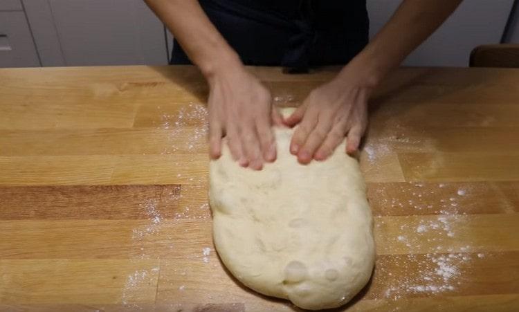 We take out the dough from the refrigerator, level it into a rectangle.