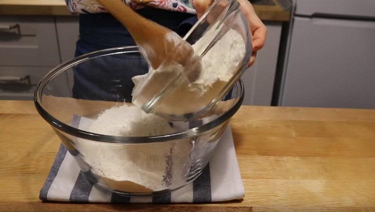 Pour the sifted flour into a large, deep bowl.