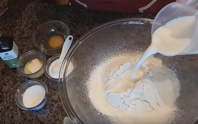 Pour hot milk into the flour.