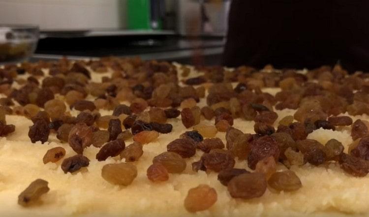 Lay the raisins on top of the marzipan layer.
