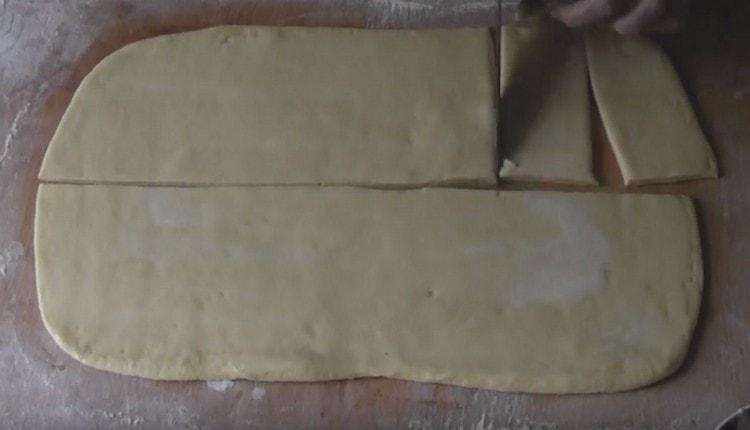 cut the rectangle into two halves along and cut each of them into strips.