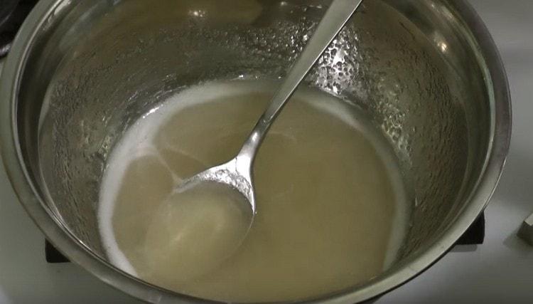 After the sugar has dissolved, add the gelatin to the hot syrup and mix.