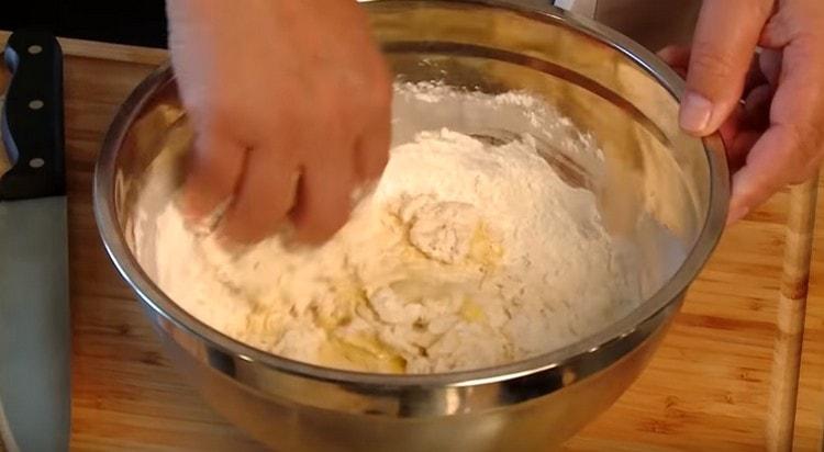 Pétrir la pâte à base de farine, sel, eau et œufs.