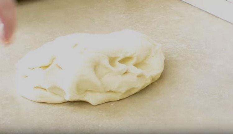 We shift the finished dough to the work surface.
