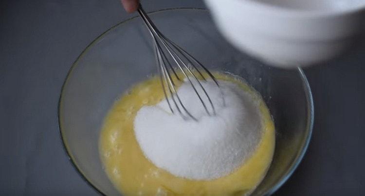 Add sugar to the egg mass.