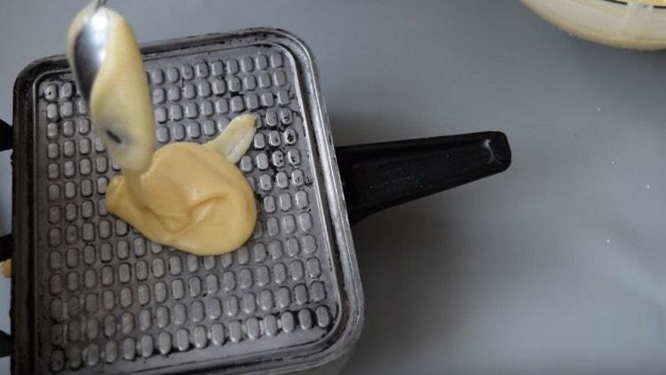 Étaler une cuillerée de pâte dans un gaufrier et faire frire les gaufres.
