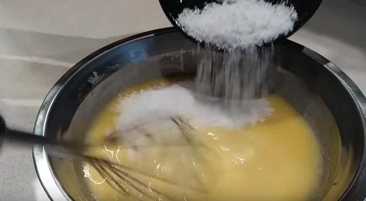 Agregue leche condensada y hojuelas de coco a la crema.