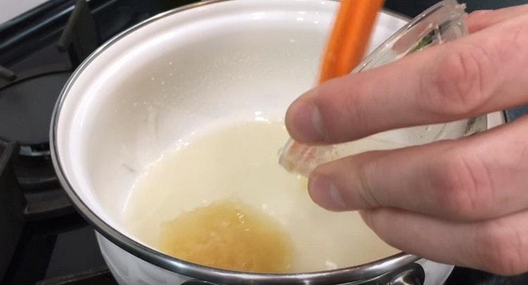 Add the swollen gelatin to the hot syrup and mix until completely dissolved.