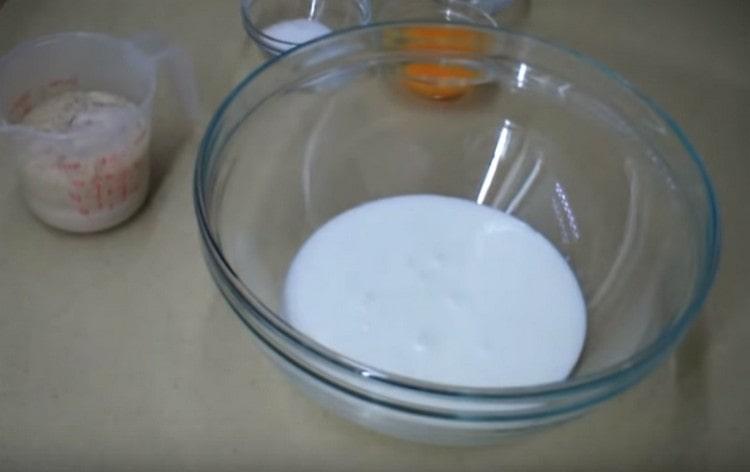 Pour kefir into a dough mixing bowl.