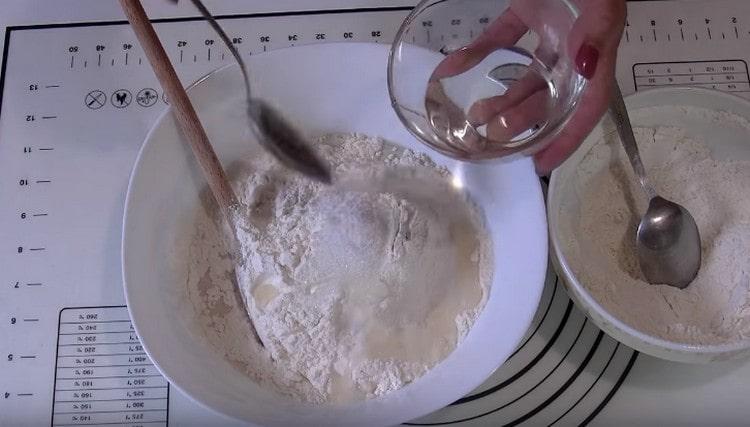 Add flour, vegetable oil, salt to the dough, mix.