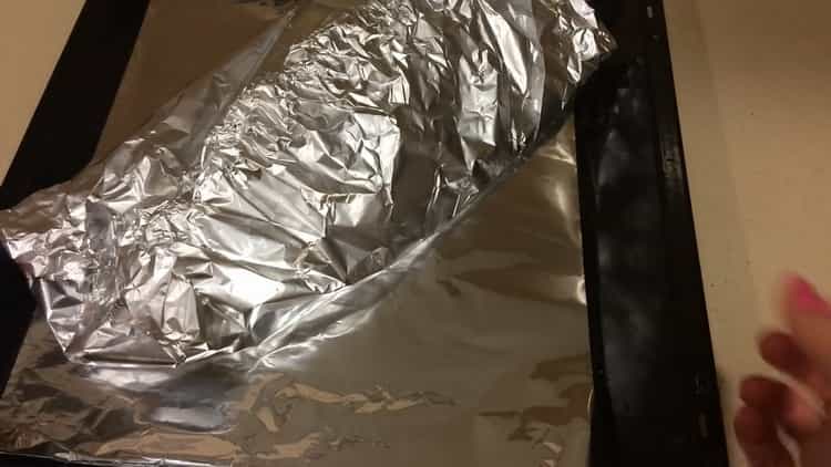 To cook mackerel in foil in the oven, preheat the oven