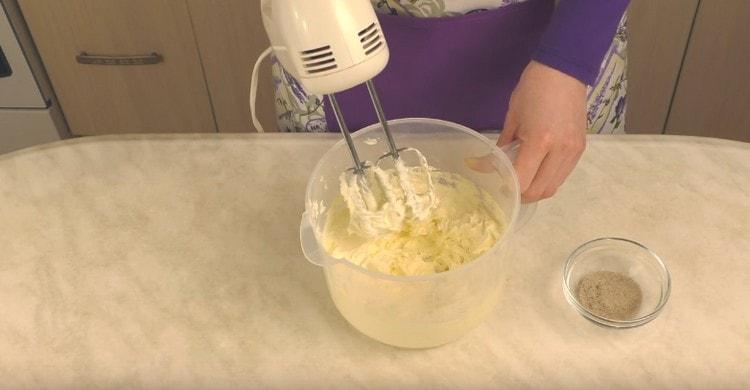 Add the icing sugar to the butter and beat with a mixer.
