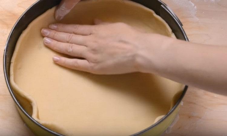 Transfer the dough into a parchment-covered form and make sides.