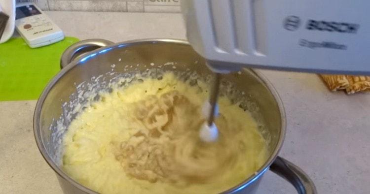 Add the cooled condensed milk to the cream and whisk again.