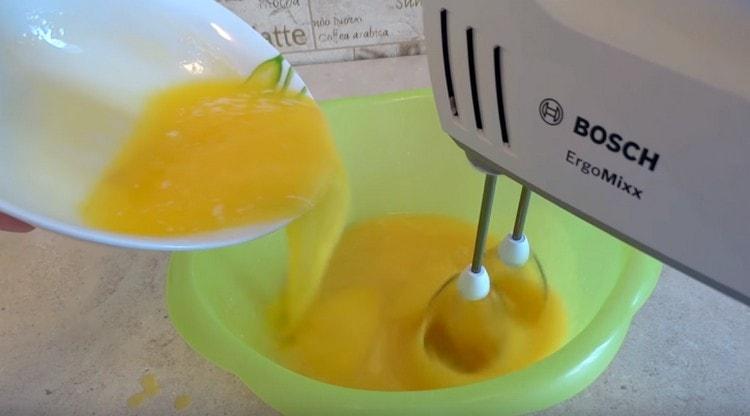 Add melted butter to the eggs.