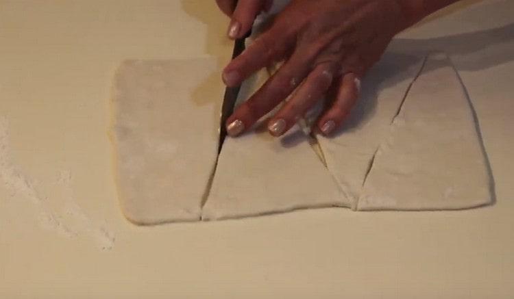 Cut the rolled dough into triangles.