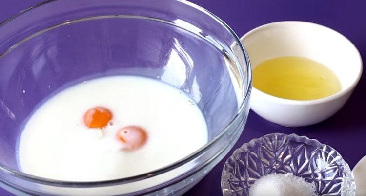 In warm milk, add egg yolks.